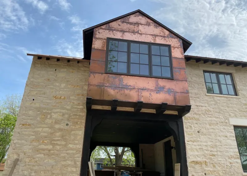 Copper metal panel facade on a stone building for Metal Roof Coating in Corona