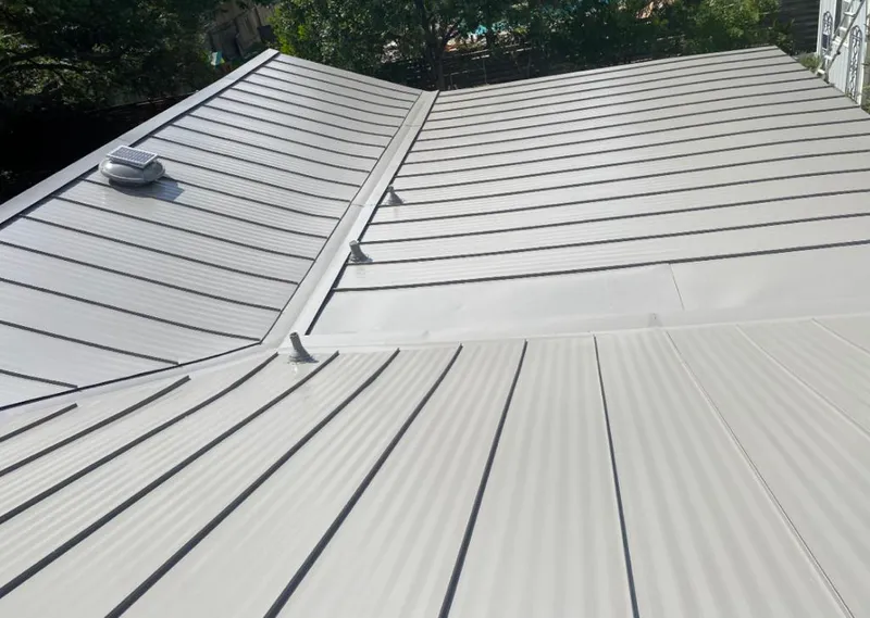 Solar attic fan installed on a metal roof for Roof Ventilation in Corona